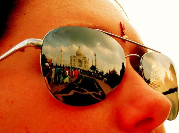 Student sunglasses reflecting the Taj Mahal in India.