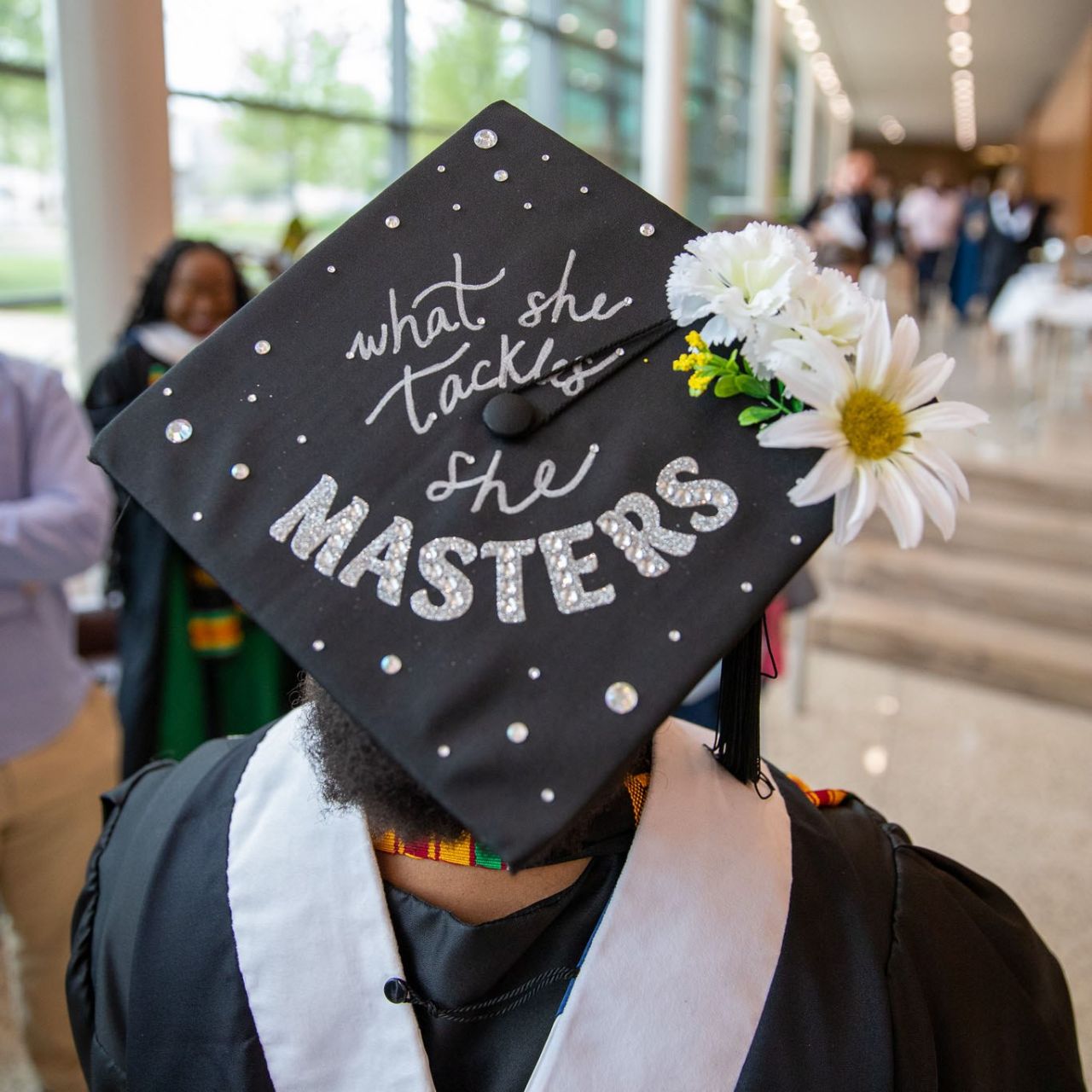 A 2023 SIA graduate decorated her cap with the words 'What she tackles, she masters.'