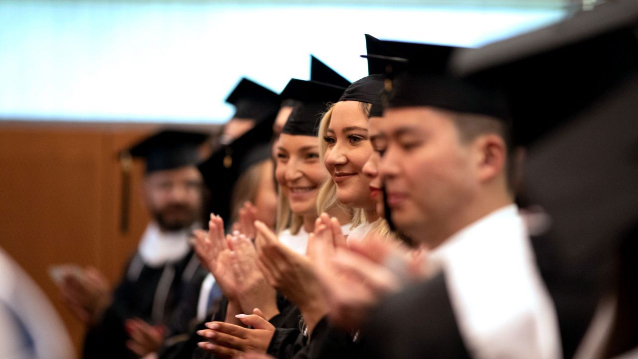 SIA graduates clapping during the ceremony.